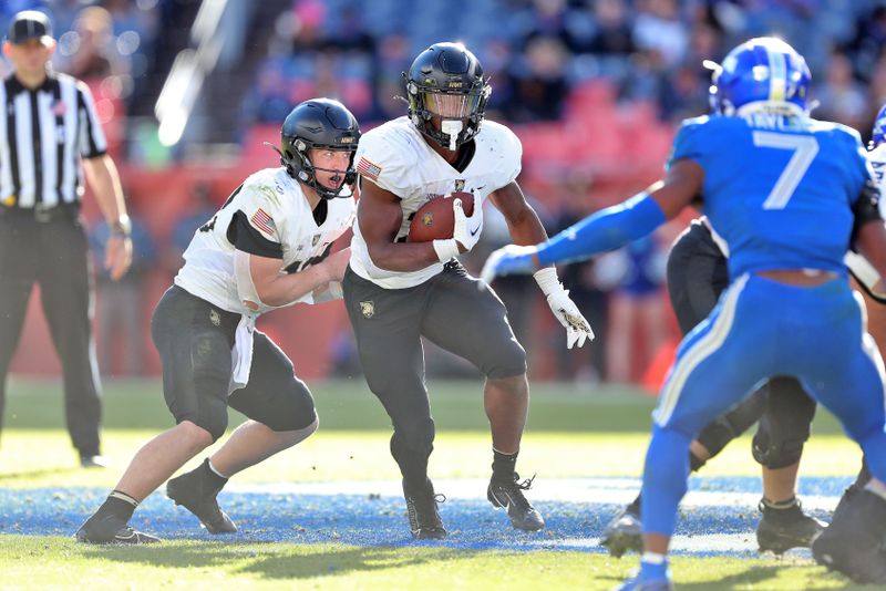 Nov 4, 2023; Denver, Colorado, USA; Army Black Knights running back Kanye Udoh (26) carries the ball against the Air Force Falcons during the second half at Empower Field at Mile High. Mandatory Credit: Danny Wild-USA TODAY Sports