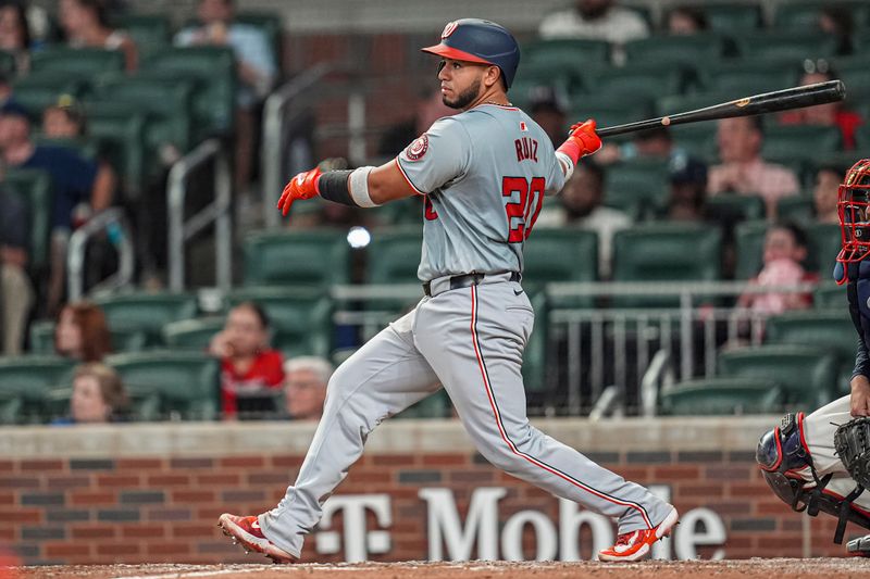 May 29, 2024; Cumberland, Georgia, USA; Washington Nationals catcher Keibert Ruiz (20) singles to drive in two runs against the Atlanta Braves during the ninth inning at Truist Park. Mandatory Credit: Dale Zanine-USA TODAY Sports