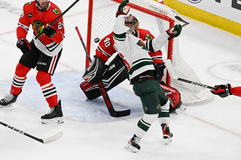 Apr 7, 2024; Chicago, Illinois, USA;  Chicago Blackhawks goaltender Arvid Soderblom (40) and Minnesota Wild right wing Mats Zuccarello (36) watch the puck during the first period at the United Center. Mandatory Credit: Matt Marton-USA TODAY Sports