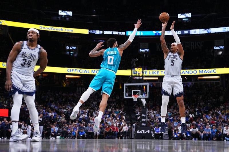 ORLANDO, FLORIDA - FEBRUARY 12: Paolo Banchero #5 of the Orlando Magic goes up for a shot against Miles Bridges #0 of the Charlotte Hornets during the third quarter at Kia Center on February 12, 2025 in Orlando, Florida. NOTE TO USER: User expressly acknowledges and agrees that, by downloading and or using this photograph, user is consenting to the terms and conditions of the Getty Images License Agreement. (Photo by Rich Storry/Getty Images)