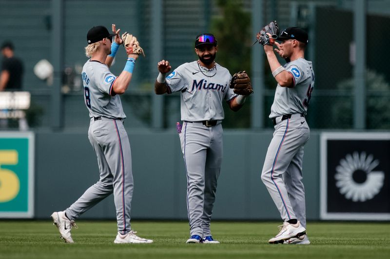 Aug 29, 2024; Denver, Colorado, USA; Miami Marlins left fielder Kyle Stowers (28) and center fielder Derek Hill (58) and right fielder Griffin Conine (56) celebrate after the game against the Colorado Rockies at Coors Field. Mandatory Credit: Isaiah J. Downing-USA TODAY Sports
