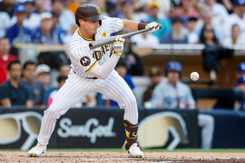 Jul 31, 2024; San Diego, California, USA; San Diego Padres right fielder Bryce Johnson (27) bunts into a fielder's choice to score shortstop Ha-Seong Kim (not pictured) during the second inning against the Los Angeles Dodgers at Petco Park. Mandatory Credit: David Frerker-USA TODAY Sports