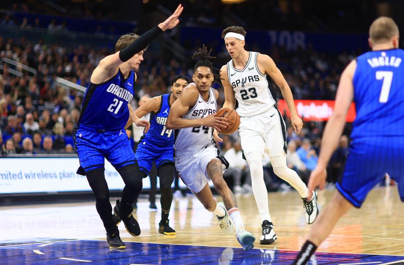 ORLANDO, FLORIDA - FEBRUARY 08: Devin Vassell #24 of the San Antonio Spurs drives on  Moritz Wagner #21 of the Orlando Magic during a game  at Kia Center on February 08, 2024 in Orlando, Florida. (Photo by Mike Ehrmann/Getty Images) NOTE TO USER: User expressly acknowledges and agrees that, by downloading and or using this photograph, User is consenting to the terms and conditions of the Getty Images License Agreement. (Photo by Mike Ehrmann/Getty Images)