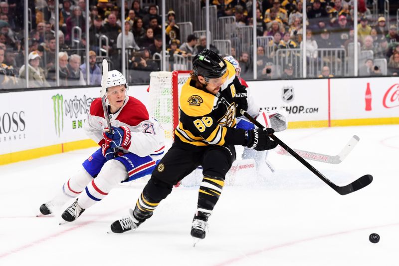 Oct 10, 2024; Boston, Massachusetts, USA; Boston Bruins right wing David Pastrnak (88) controls the puck away from Montreal Canadiens defenseman Kaiden Guhle (21) during the first period at TD Garden. Mandatory Credit: Bob DeChiara-Imagn Images