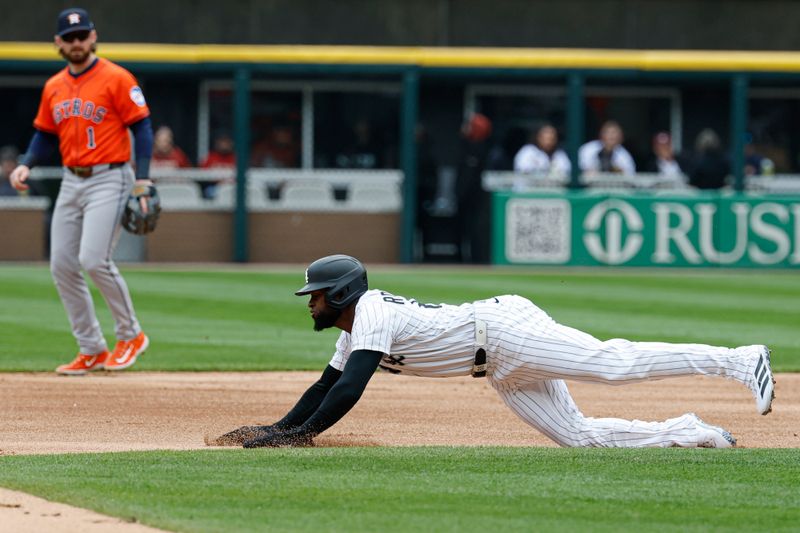 May 4, 2025; Chicago, Illinois, USA; Chicago White Sox center fielder Luis Robert Jr. (88) slides to steal second base against the Houston Astros during the first inning at Rate Field. Mandatory Credit: Kamil Krzaczynski-Imagn Images