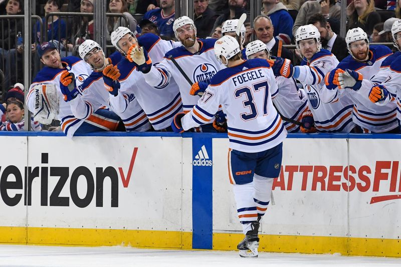 Dec 22, 2023; New York, New York, USA;  Edmonton Oilers left wing Warren Foegele (37) celebrates his goal against the New York Rangers with the Edmonton Oilers bench during the third period at Madison Square Garden. Mandatory Credit: Dennis Schneidler-USA TODAY Sports