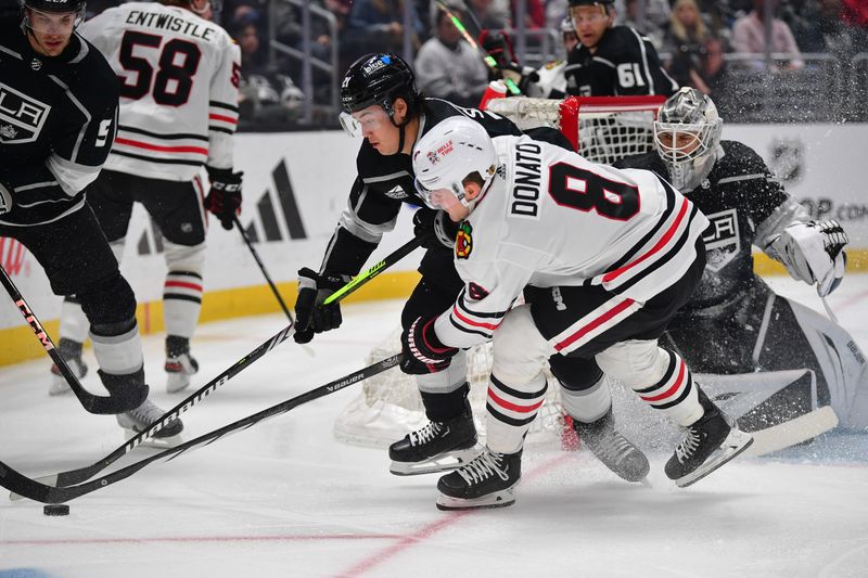 Apr 18, 2024; Los Angeles, California, USA; Chicago Blackhawks center Ryan Donato (8) plays for the puck against Los Angeles Kings defenseman Jordan Spence (21) during the first period at Crypto.com Arena. Mandatory Credit: Gary A. Vasquez-USA TODAY Sports