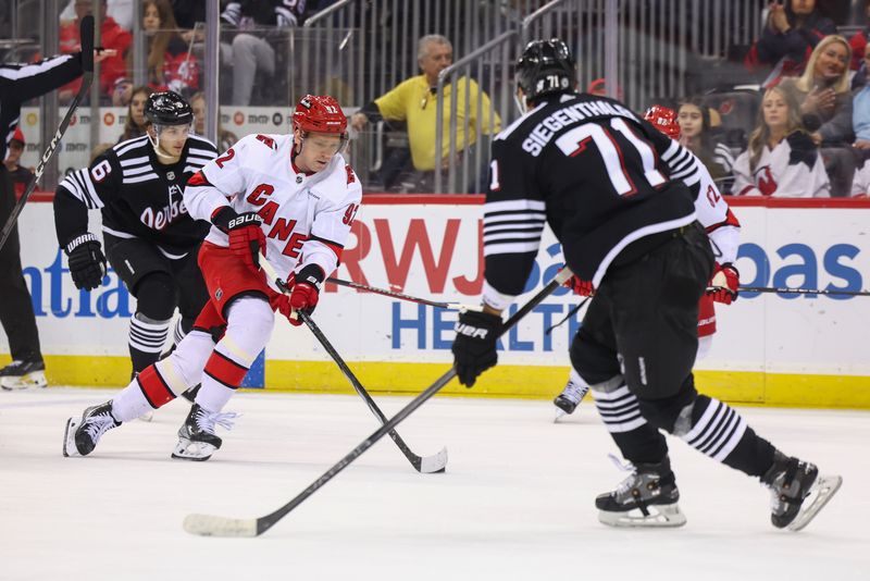 Mar 9, 2024; Newark, New Jersey, USA; Carolina Hurricanes center Evgeny Kuznetsov (92) skates with the puck against the New Jersey Devils during the third period at Prudential Center. Mandatory Credit: Ed Mulholland-USA TODAY Sports