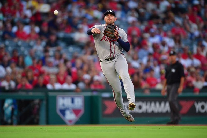 August 16, 2024; Anaheim, California, USA; Atlanta Braves third baseman Austin Riley (27) throws to first for the out against Los Angeles Angels shortstop Zach Neto (9) during the third inning at Angel Stadium. Mandatory Credit: Gary A. Vasquez-USA TODAY Sports