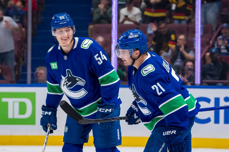 Sep 24, 2024; Vancouver, British Columbia, CAN;  Vancouver Canucks forward Aatu Raty (54) and forward Nils Hoglander (21) celebrate Hoglander’s goal against the Seattle Kraken during the first period at Rogers Arena. Mandatory Credit: Bob Frid-Imagn Images