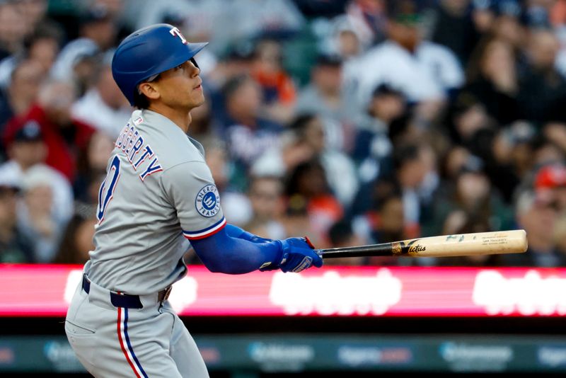 May 9, 2025; Detroit, Michigan, USA;  Texas Rangers shortstop Sam Haggerty hits an RBI single in the sixth inning against the Detroit Tigers at Comerica Park. Mandatory Credit: Rick Osentoski-Imagn Images