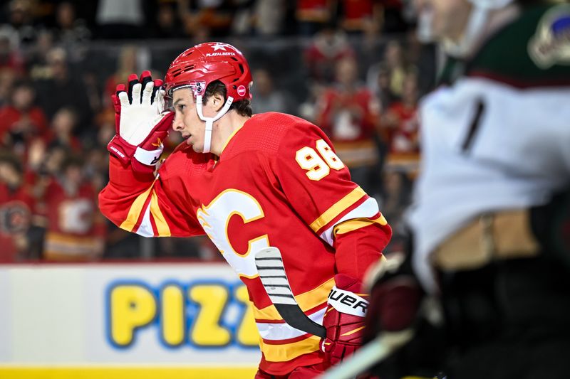 Apr 14, 2024; Calgary, Alberta, CAN; Calgary Flames left wing Andrei Kuzmenko (96) celebrates after scoring a goal against the Arizona Coyotes during the first period at Scotiabank Saddledome. Mandatory Credit: Brett Holmes-USA TODAY Sports