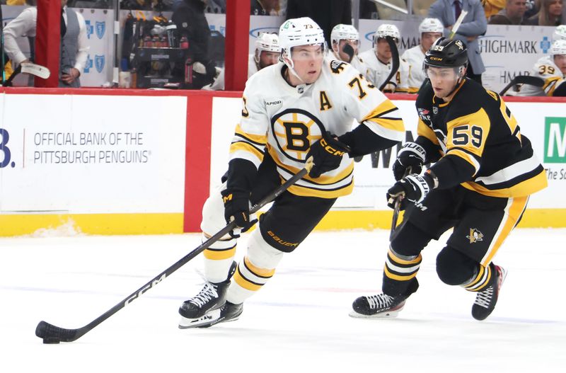 Mar 8, 2026; Pittsburgh, Pennsylvania, USA;  Boston Bruins defenseman Charlie McAvoy (73) handles the puck against Pittsburgh Penguins right wing Egor Chinakhov (59) in overtime at PPG Paints Arena. Mandatory Credit: Charles LeClaire-Imagn Images