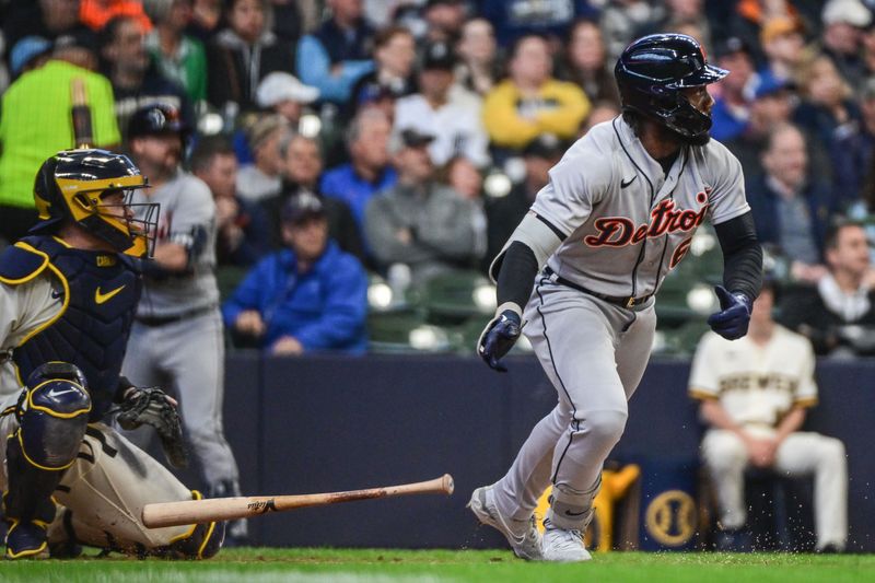 Apr 26, 2023; Milwaukee, Wisconsin, USA; Detroit Tigers left fielder Akil Baddoo (60) hits an RBI dounle in the fourth inning as Milwaukee Brewers catcher Victor Caratini (7) looks on at American Family Field. Mandatory Credit: Benny Sieu-USA TODAY Sports