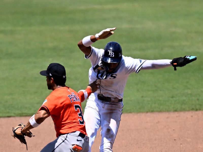 May 21, 2025; St. Petersburg, Florida, USA; Tampa Bay Rays left fielder Chandler Simpson (14) gets tagged out by Houston Astros shortstop Jeremy Pena (3) in the fifth inning  at George M. Steinbrenner Field. Mandatory Credit: Jonathan Dyer-Imagn Images