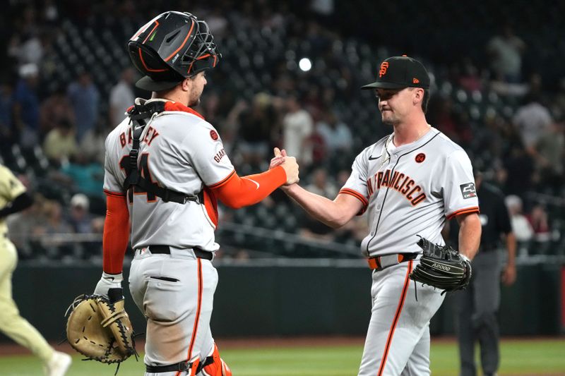 Sep 24, 2024; Phoenix, Arizona, USA; San Francisco Giants catcher Patrick Bailey (14) and pitcher Austin Warren (57) celebrate after defeating the Arizona Diamondbacks at Chase Field. Mandatory Credit: Rick Scuteri-Imagn Images