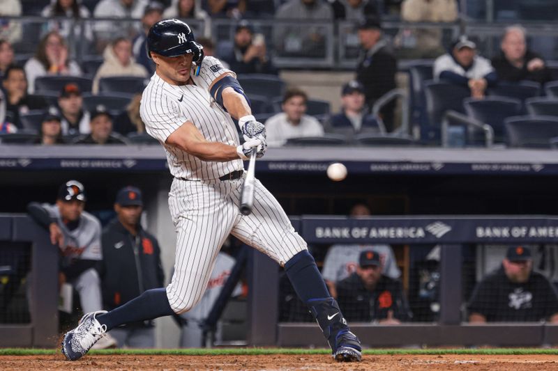 May 3, 2024; Bronx, New York, USA; New York Yankees designated hitter Giancarlo Stanton (27) hits an RBI double during the ninth inning against the Detroit Tigers at Yankee Stadium. Mandatory Credit: Vincent Carchietta-USA TODAY Sports