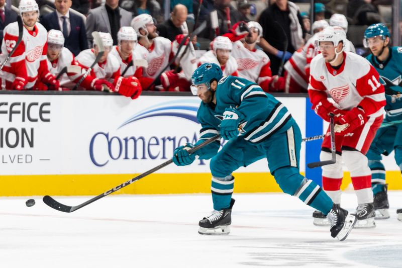 Nov 18, 2024; San Jose, California, USA; San Jose Sharks center Luke Kunin (11) shoots the puck during the second period against the Detroit Red Wings at SAP Center at San Jose. Mandatory Credit: Bob Kupbens-Imagn Images