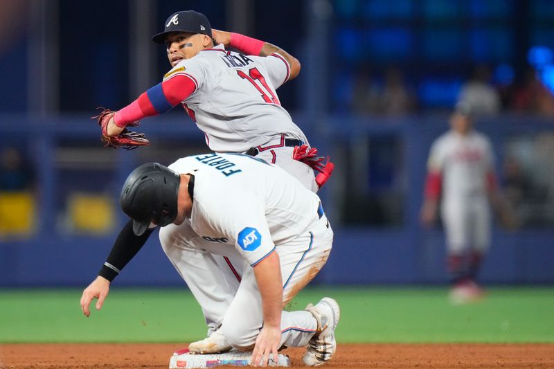 Sep 17, 2023; Miami, Florida, USA; Atlanta Braves shortstop Orlando Arcia (11) forces out Miami Marlins second baseman Luis Arraez (3) during the fifth inning at loanDepot Park. Mandatory Credit: Rich Storry-USA TODAY Sports