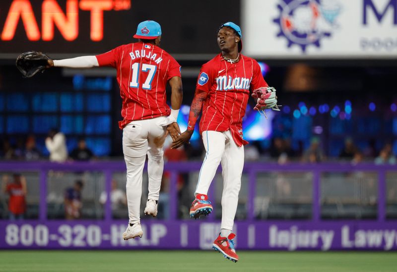 Jul 6, 2024; Miami, Florida, USA; Miami Marlins shortstop Vidal Brujan (17) and center fielder Jazz Chisholm Jr. (2) celebrate their win against the Chicago White Sox at loanDepot Park. Mandatory Credit: Rhona Wise-USA TODAY Sports