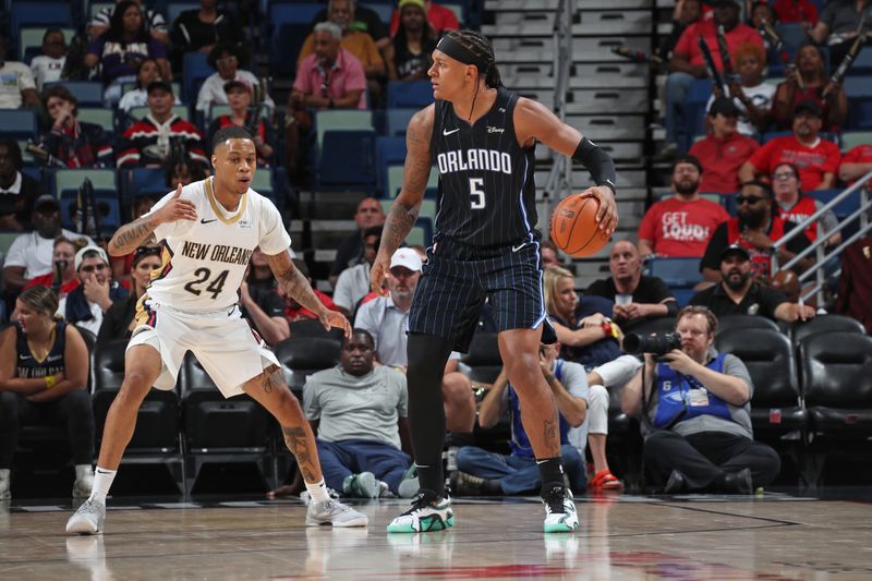 NEW ORLEANS, LA - OCTOBER 7: Jordan Hawkins #24 of the New Orleans Pelicans plays defense on Paolo Banchero #5 of the Orlando Magic on October 7, 2024 at the Smoothie King Center in New Orleans, Louisiana. NOTE TO USER: User expressly acknowledges and agrees that, by downloading and or using this Photograph, user is consenting to the terms and conditions of the Getty Images License Agreement. Mandatory Copyright Notice: Copyright 2024 NBAE (Photo by Layne Murdoch Jr./NBAE via Getty Images)