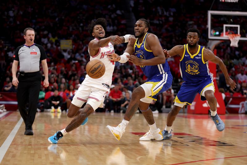 HOUSTON, TEXAS - APRIL 04: Jalen Green #4 of the Houston Rockets and Kevon Looney #5 of the Golden State Warriors battle for the ball in the first half at Toyota Center on April 04, 2024 in Houston, Texas.  NOTE TO USER: User expressly acknowledges and agrees that, by downloading and or using this photograph, User is consenting to the terms and conditions of the Getty Images License Agreement. (Photo by Tim Warner/Getty Images)