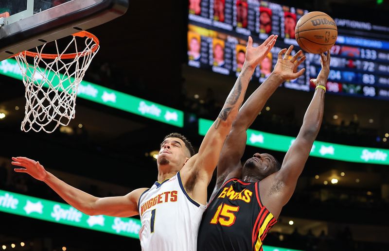 ATLANTA, GEORGIA - DECEMBER 11:  Clint Capela #15 of the Atlanta Hawks battles for a rebound against Michael Porter Jr. #1 of the Denver Nuggets during the fourth quarter at State Farm Arena on December 11, 2023 in Atlanta, Georgia.  NOTE TO USER: User expressly acknowledges and agrees that, by downloading and/or using this photograph, user is consenting to the terms and conditions of the Getty Images License Agreement.  (Photo by Kevin C. Cox/Getty Images)