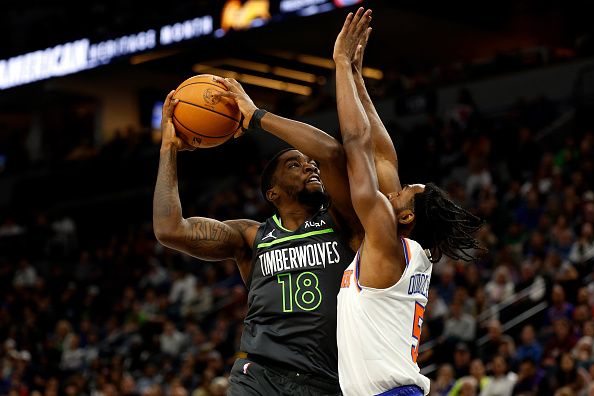 MINNEAPOLIS, MINNESOTA - NOVEMBER 20: Shake Milton #18 of the Minnesota Timberwolves goes up for a shot while Immanuel Quickley #5 of the New York Knicks defends in the first quarter at Target Center on November 20, 2023 in Minneapolis, Minnesota. NOTE TO USER: User expressly acknowledges and agrees that, by downloading and or using this photograph, User is consenting to the terms and conditions of the Getty Images License Agreement. (Photo by David Berding/Getty Images)