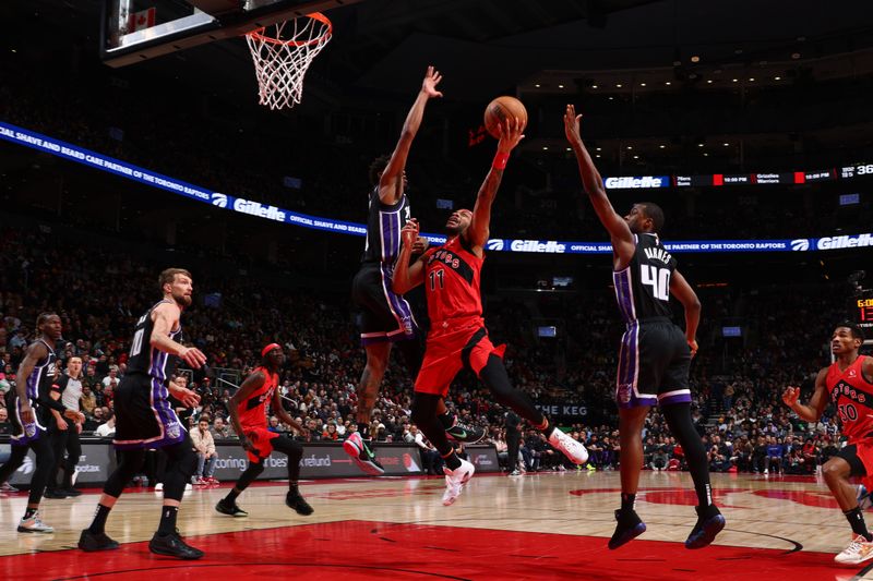 TORONTO, CANADA - MARCH 20: Bruce Brown #11 of the Toronto Raptors drives to the basket during the game against the Sacramento Kings on March 20, 2024 at the Scotiabank Arena in Toronto, Ontario, Canada.  NOTE TO USER: User expressly acknowledges and agrees that, by downloading and or using this Photograph, user is consenting to the terms and conditions of the Getty Images License Agreement.  Mandatory Copyright Notice: Copyright 2024 NBAE (Photo by Vaughn Ridley/NBAE via Getty Images)