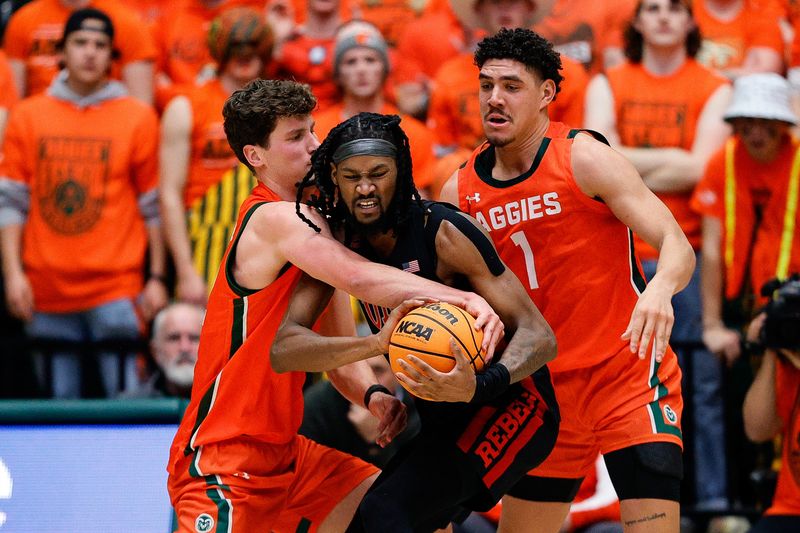 Jan 19, 2024; Fort Collins, Colorado, USA; UNLV Rebels forward Keylan Boone (20) battles for the ball with Colorado State Rams forward Patrick Cartier (12) and forward Joel Scott (1) in the second half at Moby Arena. Mandatory Credit: Isaiah J. Downing-USA TODAY Sports