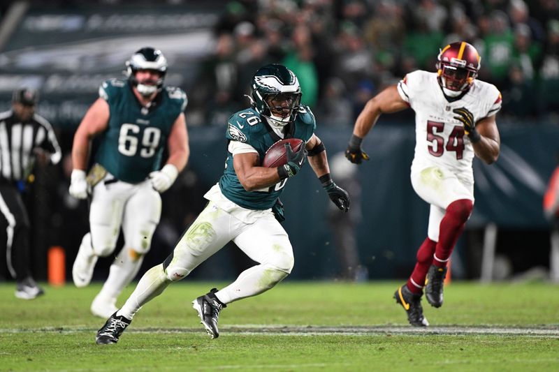 Philadelphia Eagles running back Saquon Barkley (26) runs with the ball after catching a pass during the second half of an NFL football game against the Washington Commanders, Thursday, Nov. 14, 2024, in, Philadelphia. (AP Photo/Terrance Williams)