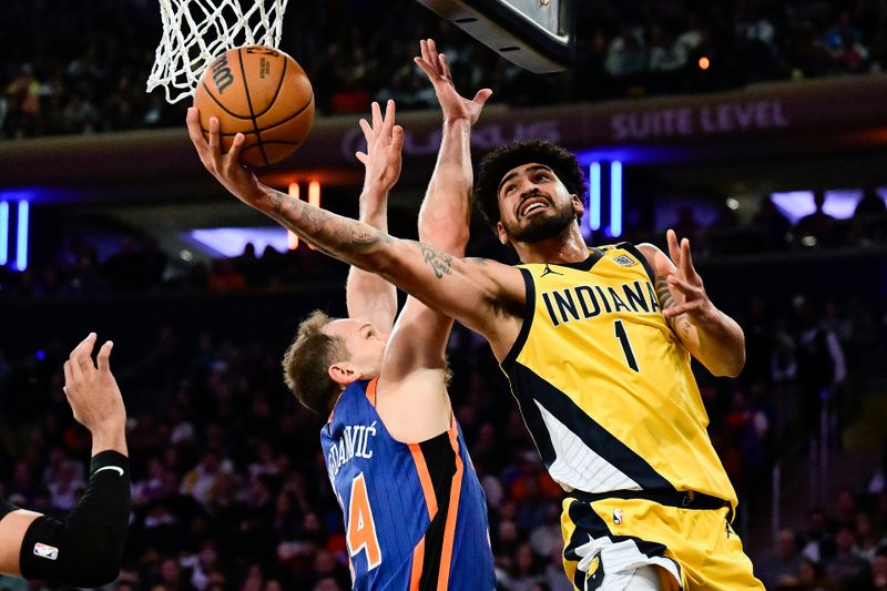 NEW YORK, NEW YORK - FEBRUARY 10:  Obi Toppin #1 of the Indiana Pacers attempts a lay up against Bojan Bogdanovic #44 of the New York Knicks during the first halfat Madison Square Garden on February 10, 2024 in New York City. NOTE TO USER: User expressly acknowledges and agrees that, by downloading and or using this photograph, User is consenting to the terms and conditions of the Getty Images License Agreement. (Photo by Steven Ryan/Getty Images)