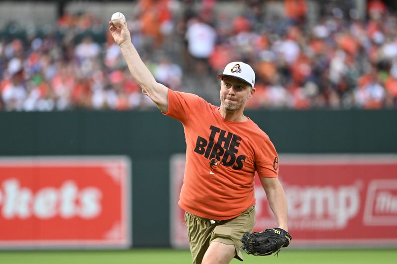 Jun 29, 2024; Baltimore, Maryland, USA; Baltimore Orioles fan Tim Byer throws a  ceremonial first pitch before the game against the Texas Rangers  at Oriole Park at Camden Yards. Mandatory Credit: Tommy Gilligan-USA TODAY Sports