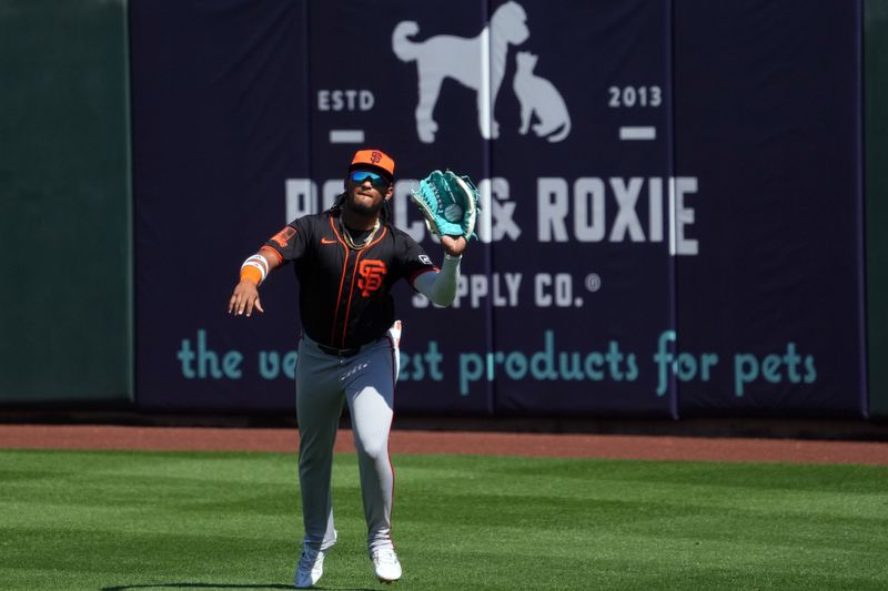 Mar 11, 2024; Surprise, Arizona, USA; San Francisco Giants right fielder Luis Matos (29) catches a fly ball against the Kansas City Royals during the first inning at Surprise Stadium. Mandatory Credit: Joe Camporeale-USA TODAY Sports