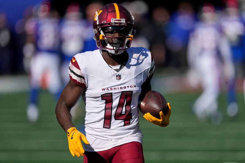 Washington Commanders wide receiver Olamide Zaccheaus (14) warms up before playing against the New York Giants in an NFL football game, Sunday, Nov. 3, 2024, in East Rutherford, N.J. (AP Photo/Seth Wenig)