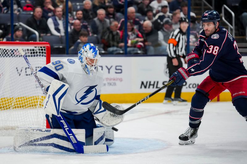 Nov 2, 2023; Columbus, Ohio, USA;  Columbus Blue Jackets center Boone Jenner (38) attempts to deflect the puck against Tampa Bay Lightning goaltender Matt Tomkins (90) in the third period at Nationwide Arena. Mandatory Credit: Aaron Doster-USA TODAY Sports