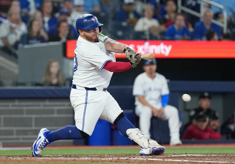 May 18, 2025; Toronto, Ontario, CAN; Toronto Blue Jays catcher Alejandro Kirk (30) hits an RBI single against the Detroit Tigers during the fourth inning at Rogers Centre. Mandatory Credit: Nick Turchiaro-Imagn Images