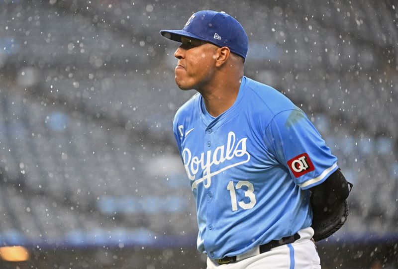 Apr 25, 2024; Kansas City, Missouri, USA;  Kansas City Royals first baseman Salvador Perez (13) walks to the dugout as the game goes into a rain delay in the sixth inning at Kauffman Stadium. Mandatory Credit: Peter Aiken-USA TODAY Sports