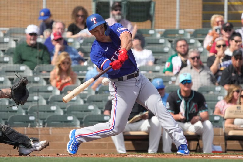 Feb 27, 2024; Salt River Pima-Maricopa, Arizona, USA; Texas Rangers left fielder Wyatt Langford (82) hits against the Arizona Diamondbacks during the first inning at Salt River Fields at Talking Stick. Mandatory Credit: Rick Scuteri-USA TODAY Sports