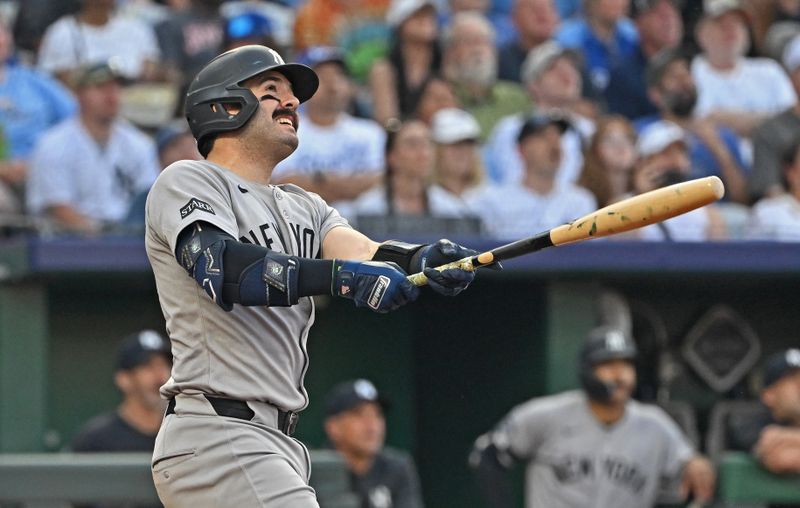 Jun 10, 2025; Kansas City, Missouri, USA;  New York Yankees catcher Austin Wells (28) hits a three-run home run in the fourth inning against the Kansas City Royals at Kauffman Stadium. Mandatory Credit: Peter Aiken-Imagn Images