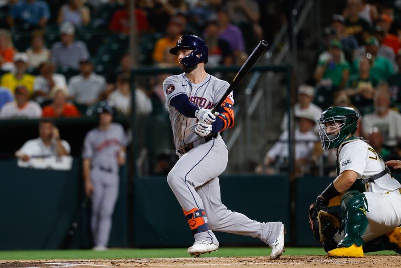 Sep 23, 2025; West Sacramento, California, USA; Houston Astros first baseman Christian Walker (8) hits a single during the second inning against the Athletics at Sutter Health Park. Mandatory Credit: Sergio Estrada-Imagn Images