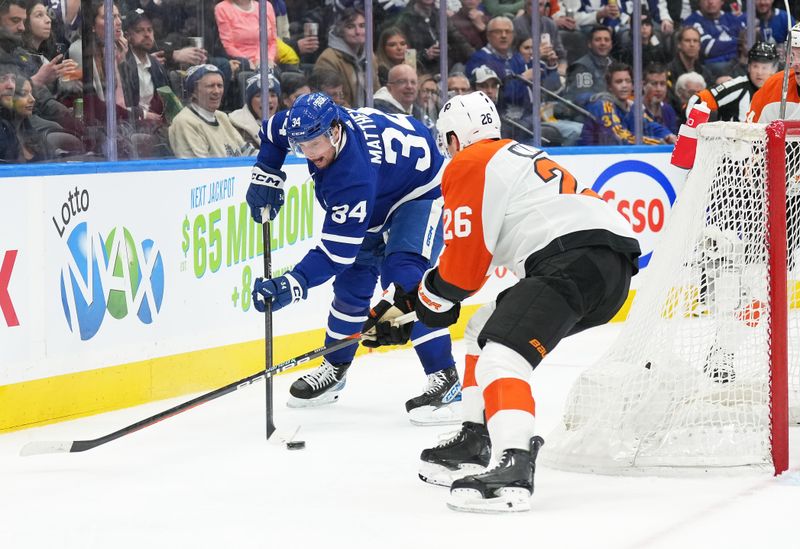 Feb 15, 2024; Toronto, Ontario, CAN; Toronto Maple Leafs center Auston Matthews (34) battles for the puck behind the net with Philadelphia Flyers defenseman Sean Walker (26) during the third period at Scotiabank Arena. Mandatory Credit: Nick Turchiaro-USA TODAY Sports