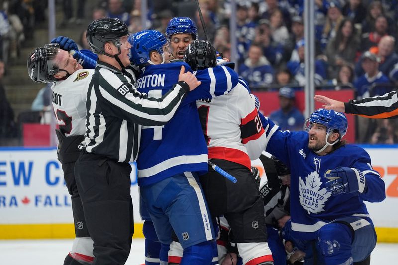 Dec 27, 2025; Toronto, Ontario, CAN; Linesperson Jonathan Deschamps tries to break up a scrum between Toronto Maple Leafs forward Scott Laughton (24) Toronto Maple Leafs forward Dakota Joshua (81) and Toronto Maple Leafs defenseman Chris Tanev (8) and Ottawa Senators forward Nick Cousins (21) and defenseman Thomas Chabot (72) during the second period at Scotiabank Arena. Mandatory Credit: John E. Sokolowski-Imagn Images