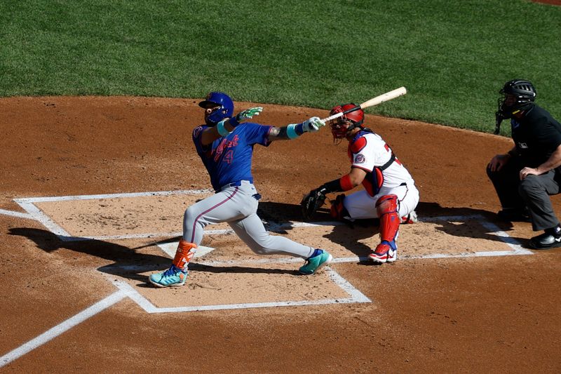 Apr 28, 2025; Washington, District of Columbia, USA; New York Mets catcher Francisco Alvarez (4) hits an RBI double against the Washington Nationals during the second inning at Nationals Park. Mandatory Credit: Geoff Burke-Imagn Images