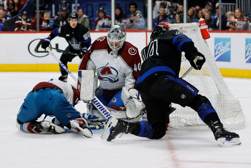 Feb 24, 2024; Denver, Colorado, USA; Colorado Avalanche goaltender Alexandar Georgiev (40) makes a save against Toronto Maple Leafs defenseman Morgan Rielly (44) as center Andrew Cogliano (11) defends in the third period at Ball Arena. Mandatory Credit: Isaiah J. Downing-USA TODAY Sports