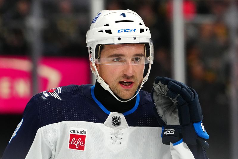 Nov 2, 2023; Las Vegas, Nevada, USA; Winnipeg Jets defenseman Neal Pionk (4) talks to a team mate before a face off against the Vegas Golden Knights during the first period at T-Mobile Arena. Mandatory Credit: Stephen R. Sylvanie-USA TODAY Sports