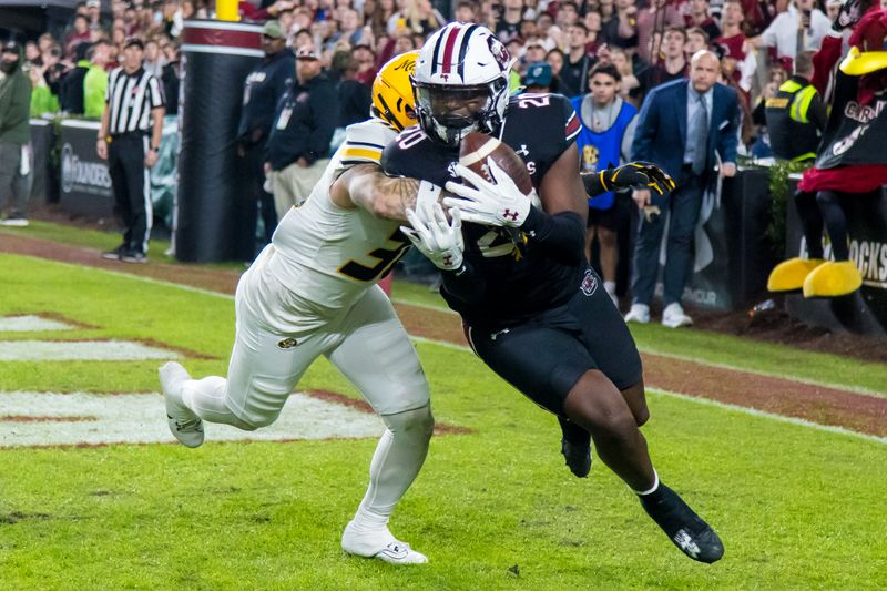 Nov 16, 2024; Columbia, South Carolina, USA; South Carolina Gamecocks tight end Michael Smith (20) makes a touchdown reception as Missouri Tigers linebacker Chuck Hicks (30) defends in the second half at Williams-Brice Stadium. Mandatory Credit: Jeff Blake-Imagn Images