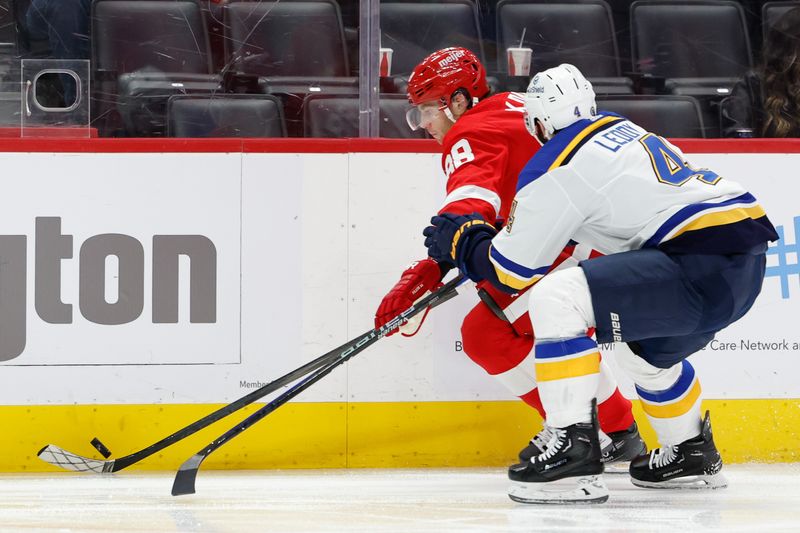 Feb 24, 2024; Detroit, Michigan, USA;  Detroit Red Wings right wing Patrick Kane (88) skates with the puck chased by St. Louis Blues defenseman Nick Leddy (4) in the second period at Little Caesars Arena. Mandatory Credit: Rick Osentoski-USA TODAY Sports