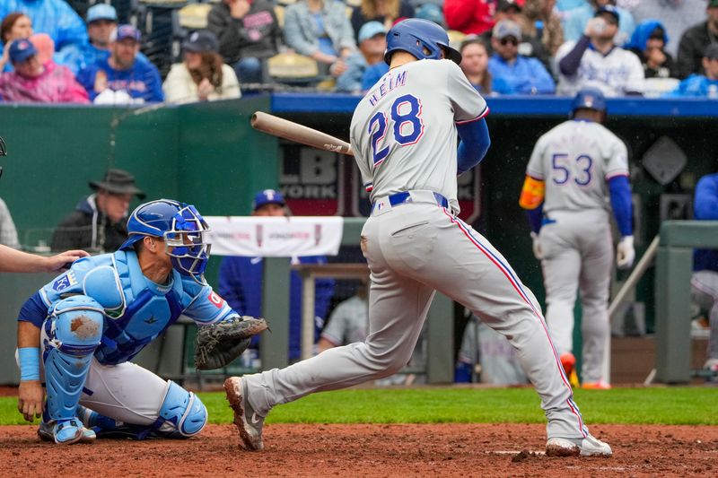 May 5, 2024; Kansas City, Missouri, USA; Texas Rangers catcher Jonah Heim (28) hits a game-tying solo home run against the Kansas City Royals in the ninth inning at Kauffman Stadium. Mandatory Credit: Denny Medley-USA TODAY Sports