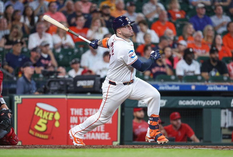 May 22, 2024; Houston, Texas, USA; Houston Astros catcher Victor Caratini (17) hits a double during the third inning against the Los Angeles Angels at Minute Maid Park. Mandatory Credit: Troy Taormina-USA TODAY Sports